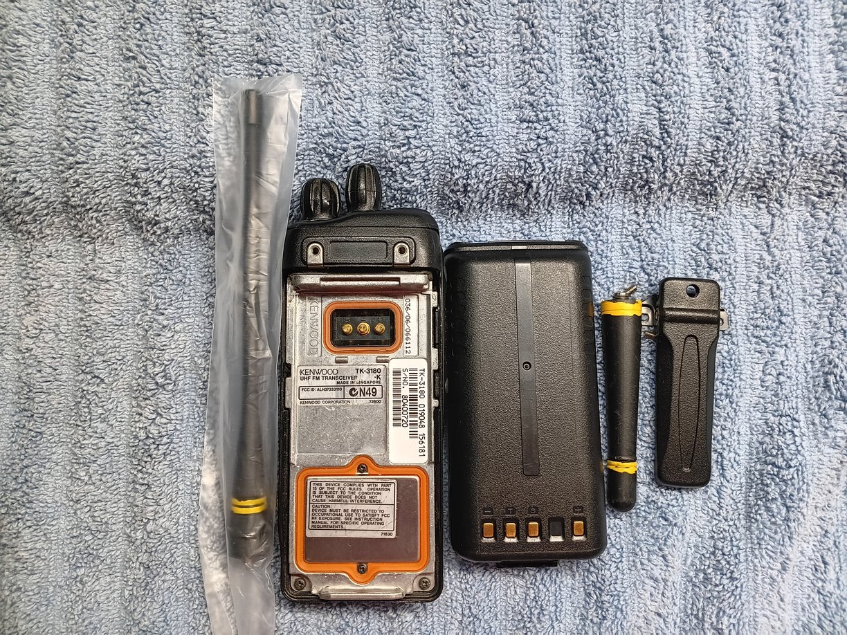 Back view of Kenwood TK-3180 radio showing screen, battery, antenna's & clip